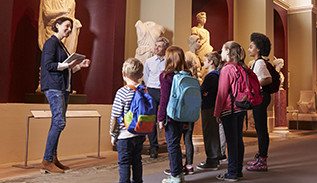 Children and tour guide at a museum.
