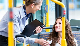 Two women talking on a bus.